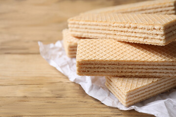 Delicious cream wafers on wooden table, closeup. Space for text