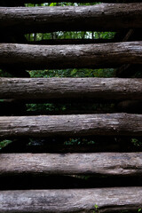 close up of vertical dark wooden logs 