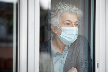 Depressed senior woman in quarantine at home suffers from loneliness