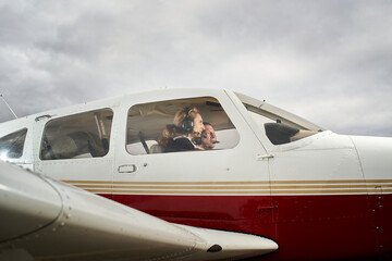 Plane in flight. Female flight instructor giving flight lessons to a student. © CarlosBarquero