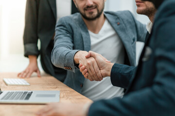 close up. handshake of business people sitting at the office Desk