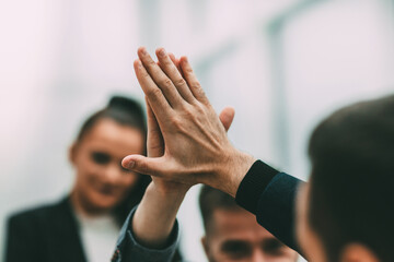 close up. young employees giving each other a high five