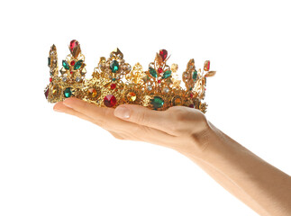 Woman holding beautiful golden crown on white background, closeup. Fantasy item © New Africa