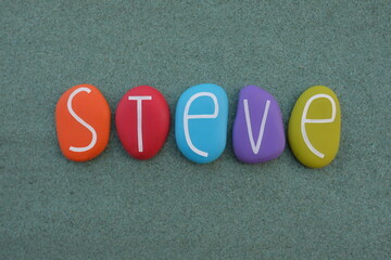 Steve, masculine given name composed with multicolored stone letters over green sand