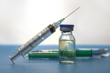 Medicine bottle for injection and syringe with medical vials for vaccination, selective focus