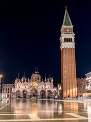 Bell tower and historical buildings at night at Piazza San Marco in Venice, Italy.