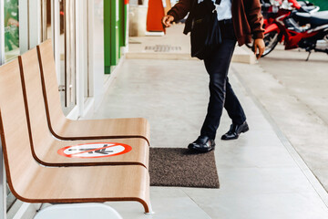 Fototapeta premium Alternative seating mark for social distance rules in front of the bank distance for one seat from other people to protect from Corona Virus(COVID-19), Social distancing for infection risk.