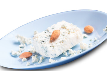 Blue cheese dor blue and almonds on blue plate isolated on white