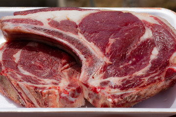 Red t bone large steaks. Fresh raw meat pieces on white tray