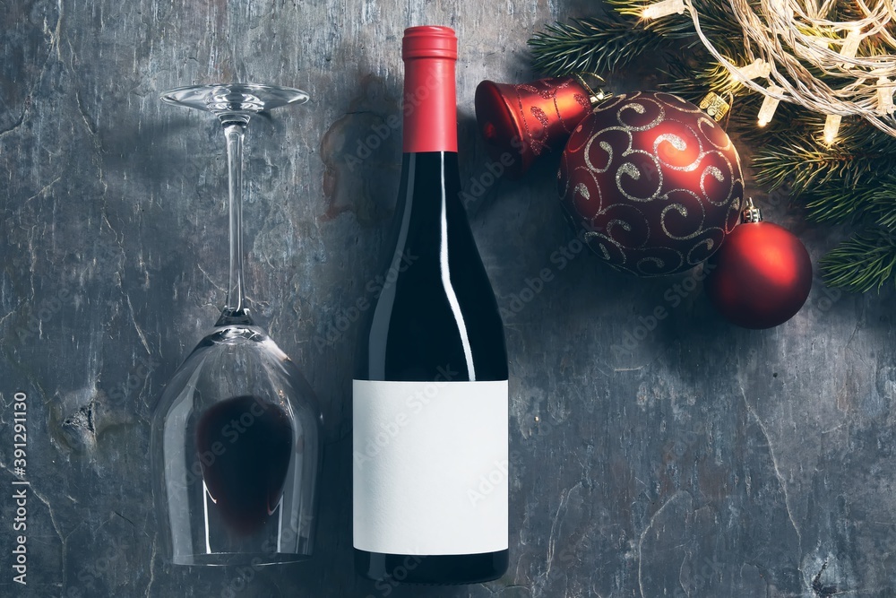 Wall mural top view of bottle of red wine with blank white label with christmas decorations on dark background.