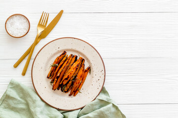 Overhead view of sweet potato fries with spices and herbs