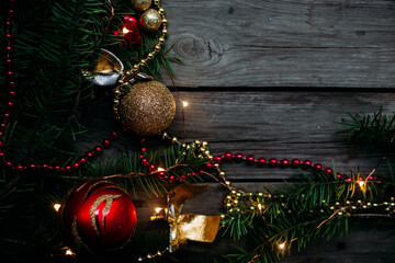 New Year and Christmas composition of a live fir tree and toys in red tones. Place for text