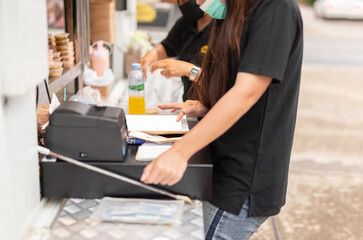 Selected focus female cashier making ordering via tablet connected to wifi indoors.