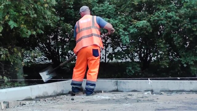 worker repairs the road