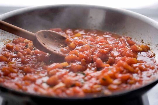 Close up of boiling tomato sauce on pan