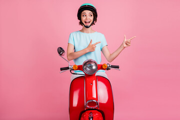 Photo of surprised nice positive lady ride red moped point empty space wear blue outfit slam...