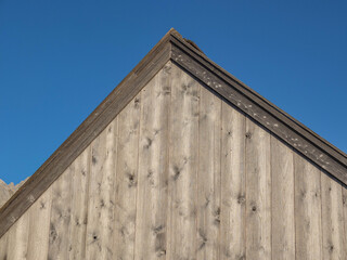 View of a gable of a wooden house.