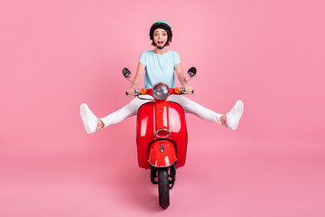 Photo of cheerful funny young lady ride red moped legs up like speed wear t-shirt slam trousers...