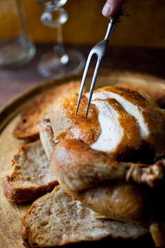 Chicken roast with thyme and garlic poked by a fork