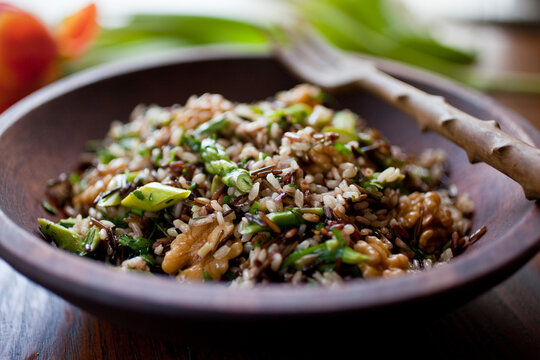 Close up of wild and brown rice salad with asparagus and walnuts