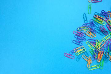 disorganize paper clips on blue background