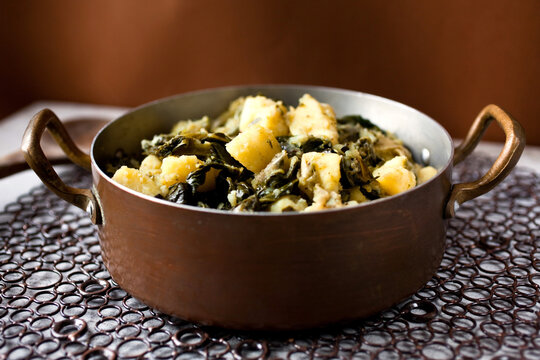 Potatoes and collard in pot