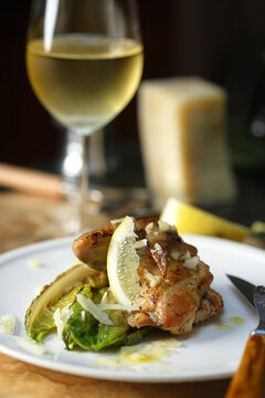 Chicken wing with endive and glass of white wine
