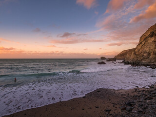 Trevaunce Cove Cornwall in Autumn with swimmers