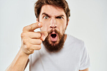 emotional man with a beard gesturing with his hands close-up studio aggression