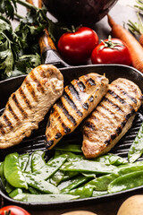 Grilled chicken breast in grill pan with sweet peas and seasoning vegetable