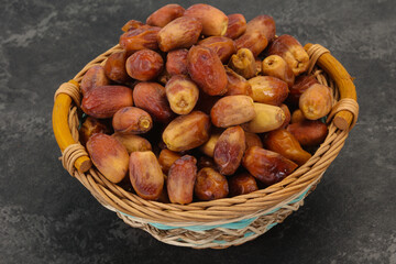 Fototapeta na wymiar Sweet tasty dry dates in the basket