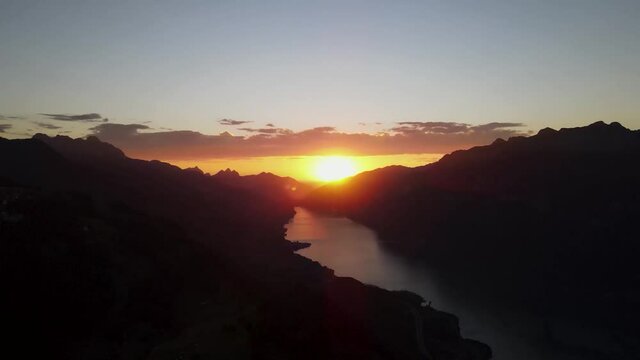 Sunset in a valley with the Walensee through mountains in Flums Switzerland - Drone Timelapse 4k Video