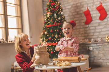 Mother and daughter making gingerbread Christmas cookies