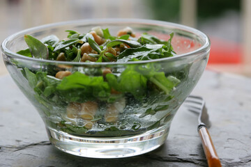 Close up of green salad with herbs in bowl