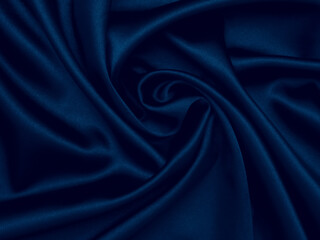 Smooth elegant dark blue silk can use as background. Decoration design. Soft focus. Luxury and sexy concept. Abstract crumpled blue glittering satin fabtic. Dark backdrop with curves, luxury fashion.