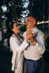 Dance of the bride and father. Evening wedding.
