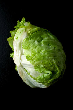 Close up of iceberg lettuce on black background