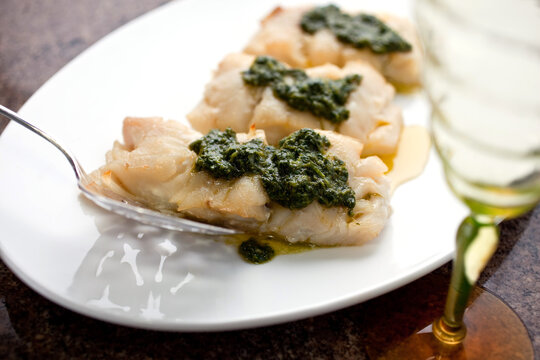 Baked cod with chermoula on plate