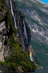 Obraz premium Rainbow under waterfall in Geiranger Norway