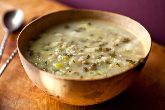 Close up of dal soup with apples and coconut tarka bowl