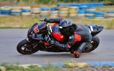 Motorcycle practice leaning into a fast corner on track