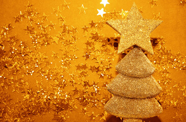creative holiday concept: shape christmas tree  made from glitters. golden  stars on yellow  paper...