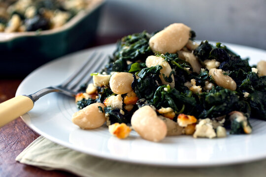 Close up of baked beans with spinach and feta
