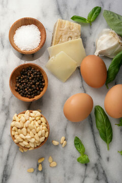 Close up of eggs, cheese, seeds, salt and black pepper on table
