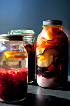 Close up of jars with alcohol and fruits