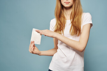 Girl with a pad on a blue background critical days menstruation hygiene appearance