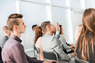 close up. business seminar participants ask questions.