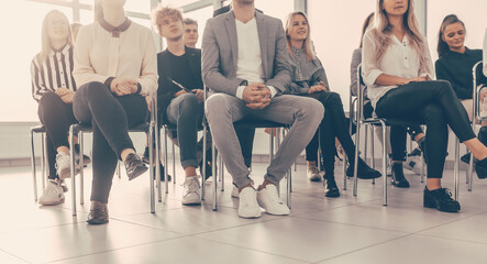 background image of a group of employees sitting in a conference room