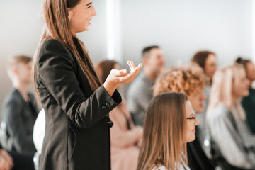 close up. young woman standing among the audience in the confer