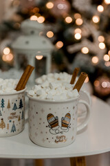 Obraz na płótnie Canvas Christmas, New Year interior decorated table with cups, marshmallows and cinnamon